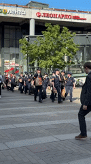 Uniformed group moves through Saint Petersburg amid architectural documentation