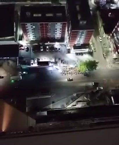 Night gathering observed at Caracas intersection amid high-rises