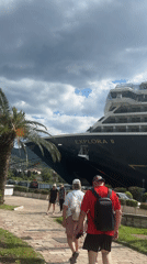 Tourists explore historic Kotor as cruise ship docks, stage prepared