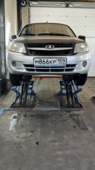 Silver Lada elevated on lifts in Chaikovsky repair shop