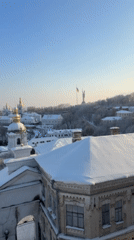 Snow blankets historic Kyiv monastery complex under clear skies