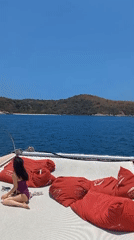 Woman relaxes on catamaran deck in Bang Sare, Thailand