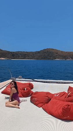 Woman relaxes on catamaran deck in Bang Sare, Thailand