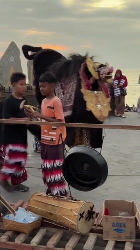 Bali sunset hour: surf, fire, dance, and beach crowds
