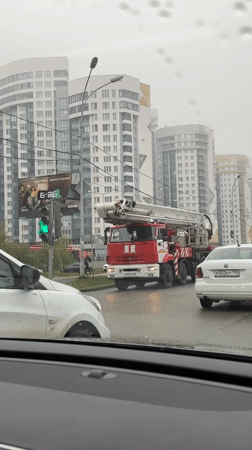 Fire truck responds through wet Yekaterinburg intersection