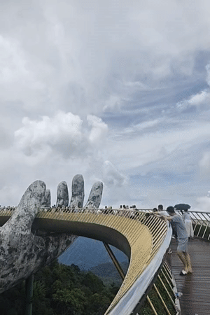 Vietnam's Golden Bridge on a cloudy morning, tourists walking