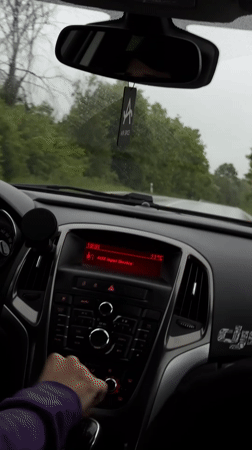 Driver navigates wet roads in Lovech, Bulgaria evening