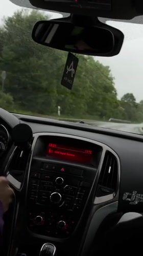 Driver navigates wet roads in Lovech, Bulgaria evening