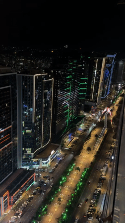 Batumi's illuminated skyline at night, shot from above
