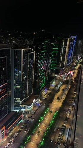 Batumi's illuminated skyline at night, shot from above