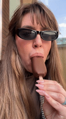 Woman enjoys chocolate ice cream in Tbilisi public square