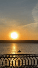 Sunset over water captured by witnesses on bridge