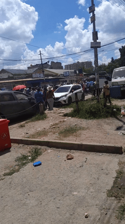 Crowd gathers on Nairobi street near commercial area