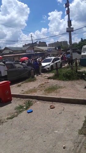 Crowd gathers on Nairobi street near commercial area