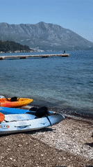 Kayakers prepare for water activities on sunny Budva beach