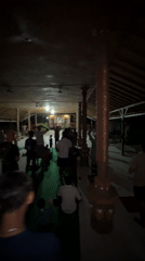 Community gathering observed at temple pavilion in Sawan, Indonesia