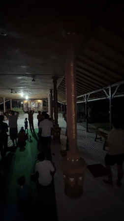 Community gathering observed at temple pavilion in Sawan, Indonesia