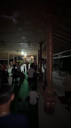 Community gathering observed at temple pavilion in Sawan, Indonesia