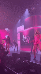 Female singer performs in pink outfit at London concert