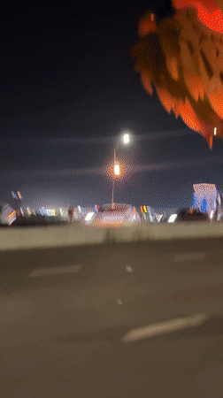 Night traffic crosses illuminated dragon bridge in Đà Nẵng