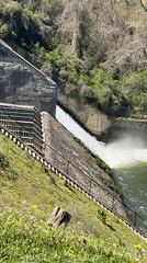 Spring morning at Pancharevo Lake shows active dam, kayakers