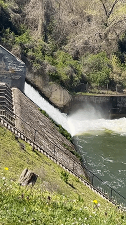 Spring morning at Pancharevo Lake shows active dam, kayakers