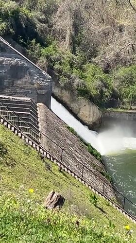 Spring morning at Pancharevo Lake shows active dam, kayakers