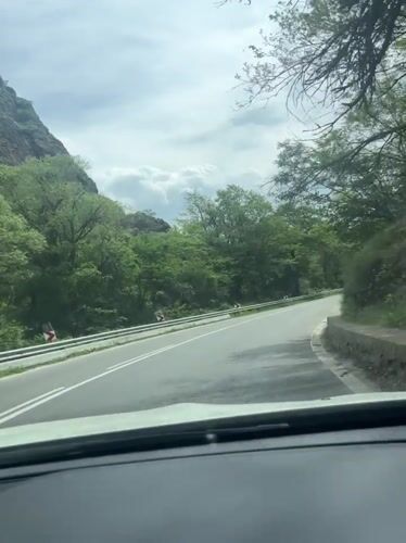 Morning traffic navigates mountain road near Rila Bulgaria