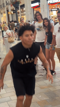 Breakdancers flip and spin through a festive Málaga street