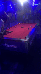 Night out at a Nigerian bar: pool, grilled food, neon lights