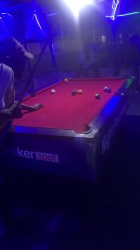 Night out at a Nigerian bar: pool, grilled food, neon lights