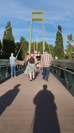 Summer evening strolls on a Kaliningrad pedestrian bridge