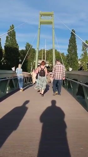Summer evening strolls on a Kaliningrad pedestrian bridge