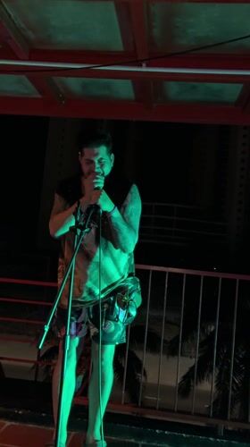 Street musician performs evening balcony concert in Da Nang