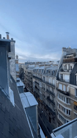 Rooftop views across Paris as daylight fades to dusk
