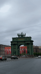 Daily life continues around Saint Petersburg's Narva Triumphal Arch