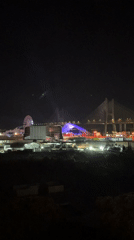 Night festival in Loures with Ferris wheel and bridge backdrop