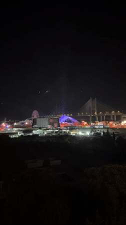 Night festival in Loures with Ferris wheel and bridge backdrop