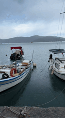 Tourist takes rainy harbor selfie in Fethiye, Turkey