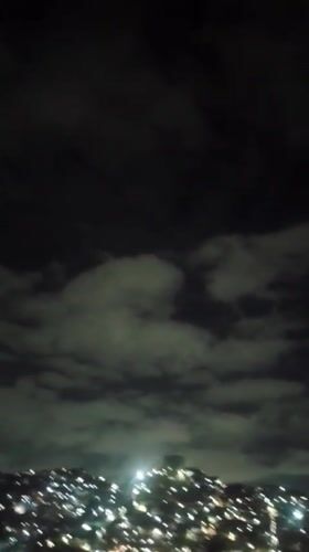 Pre-dawn Caracas cityscape observed from multiple indoor vantage points