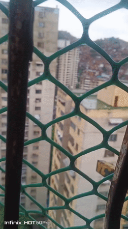 Witness documents Caracas barrios under overcast skies June evening