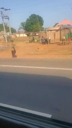 Vehicle passenger films roadside scenery in Gwagwada, Nigeria