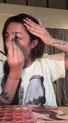 Woman demonstrates makeup application techniques in recorded session