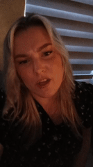 Woman observed singing indoors in dim lighting