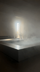 Misty water art installation documented in Milan gallery space