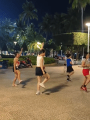 Nighttime coastal city scenes with dancing, beaches, and urban views