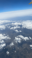 Ryanair passengers document aerial views during morning flight