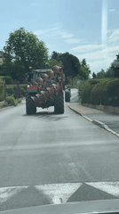 Red tractor pulls plow down road in Chambœuf
