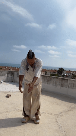 Rooftop dancing and cat leisure captured in Antalya afternoon