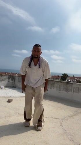 Rooftop dancing and cat leisure captured in Antalya afternoon